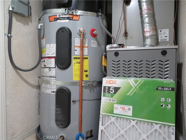 utility room featuring heating unit and water heater