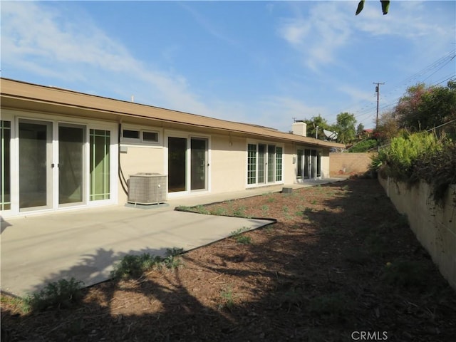 rear view of house with cooling unit and a patio area