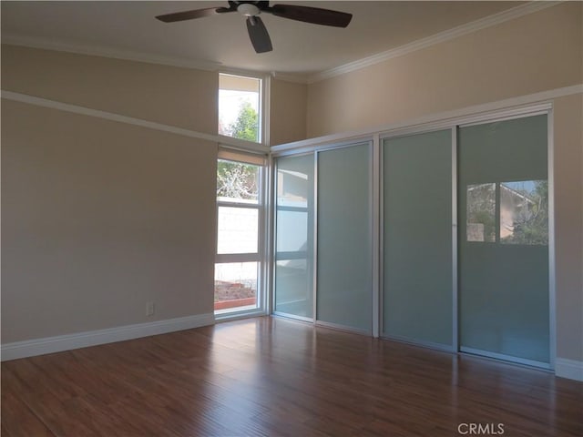 unfurnished room with ceiling fan, crown molding, and dark hardwood / wood-style floors