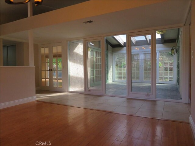 doorway with french doors and wood-type flooring