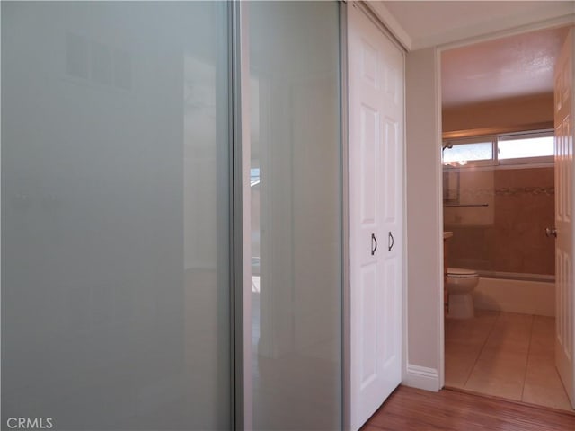 hall with light tile patterned floors