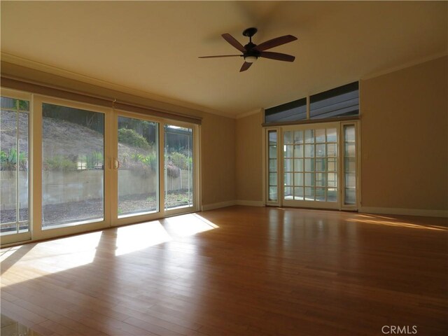 spare room with wood-type flooring, lofted ceiling, ceiling fan, and crown molding