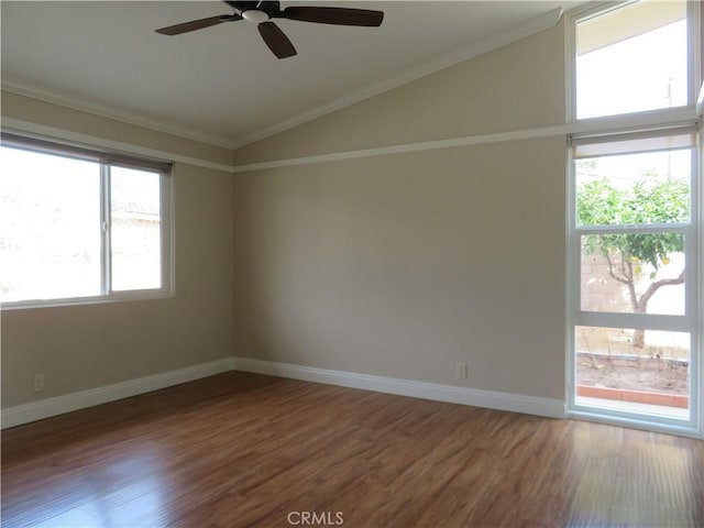 empty room with dark hardwood / wood-style flooring, vaulted ceiling, ceiling fan, and ornamental molding