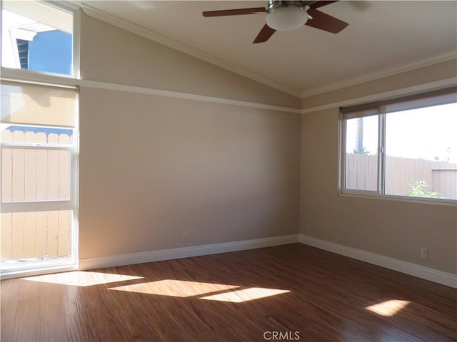 spare room featuring hardwood / wood-style floors, ceiling fan, lofted ceiling, and crown molding