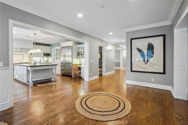 interior space featuring dark wood-style floors, ornamental molding, baseboards, and recessed lighting