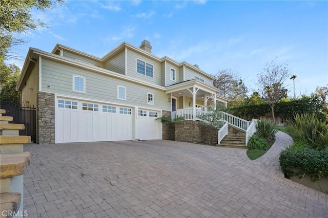 view of front of property with a porch and a garage