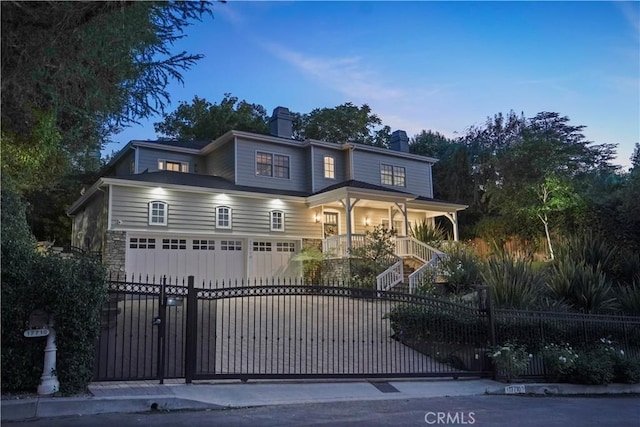 view of front of property with a fenced front yard, a gate, a porch, and stairs