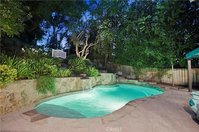 view of pool featuring a patio area, a fenced backyard, and a fenced in pool