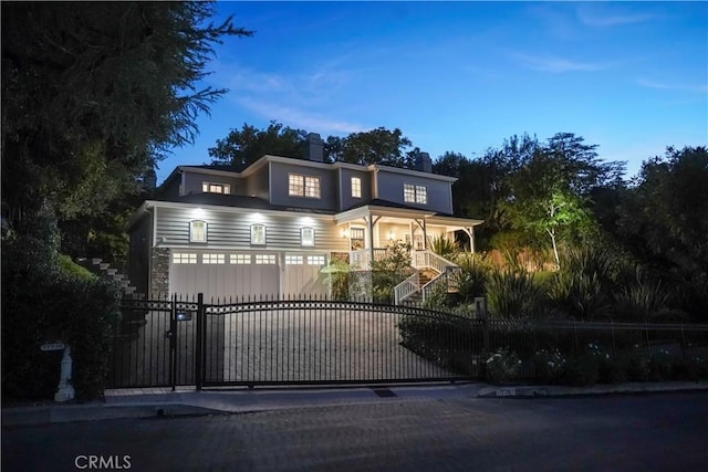 view of gate with a fenced front yard and stairway