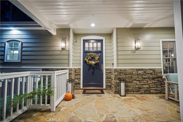 doorway to property with stone siding