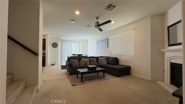 living room with light carpet and ceiling fan