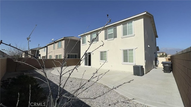 rear view of property with central AC and a patio area