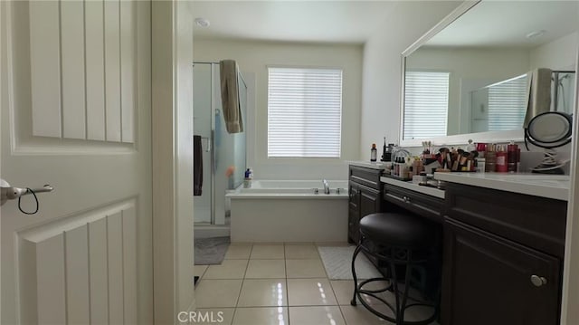 bathroom with tile patterned floors, vanity, and independent shower and bath