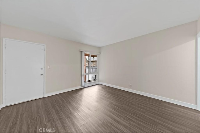 spare room featuring dark hardwood / wood-style flooring