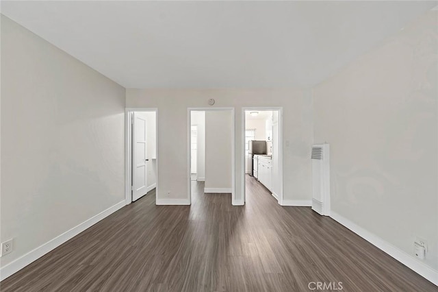 spare room with dark hardwood / wood-style floors