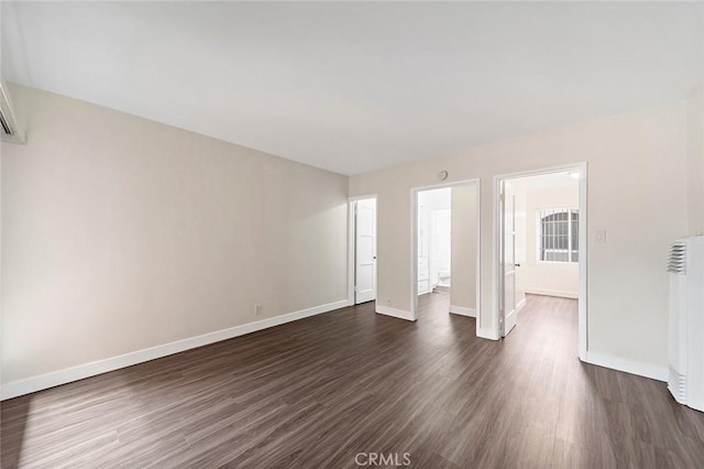 spare room featuring dark hardwood / wood-style flooring