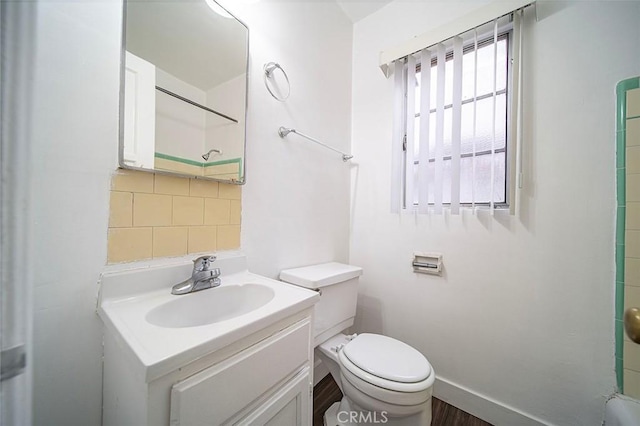 bathroom featuring decorative backsplash, vanity, and toilet