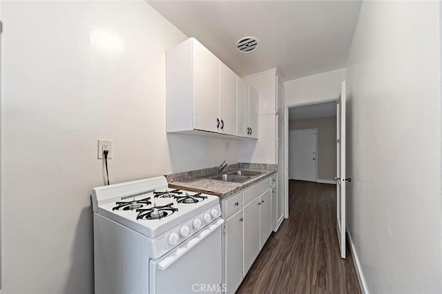 kitchen with white cabinets, dark hardwood / wood-style flooring, white range oven, and sink