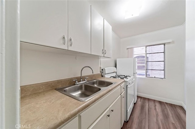 kitchen featuring white gas range, white cabinetry, sink, and dark hardwood / wood-style flooring