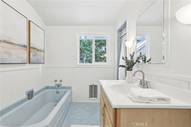 bathroom featuring a washtub and vanity