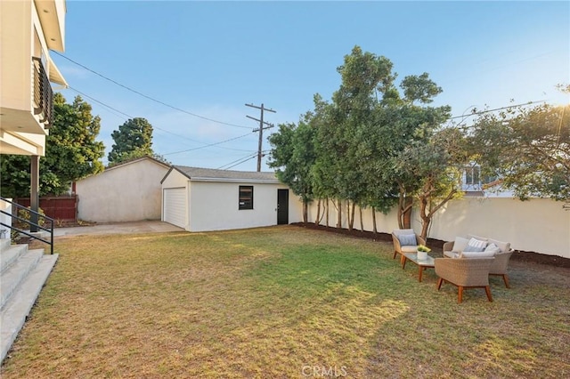 view of yard with a garage and an outdoor structure