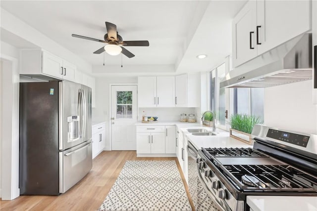 kitchen with sink, white cabinets, and appliances with stainless steel finishes