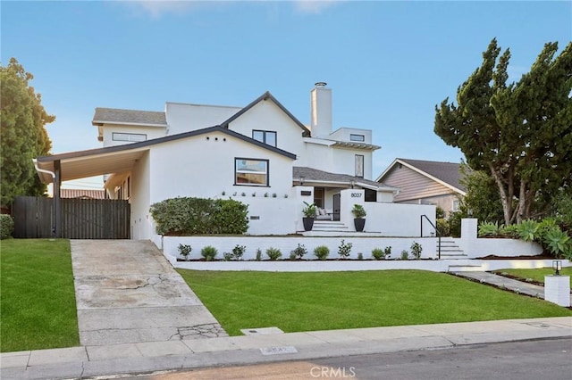 view of front of house featuring a front lawn and a carport