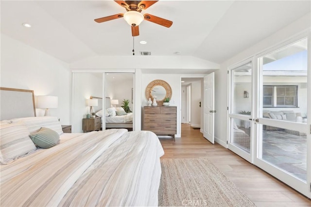 bedroom featuring light hardwood / wood-style flooring, vaulted ceiling, ceiling fan, access to exterior, and a closet