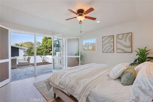 bedroom featuring light hardwood / wood-style floors, ceiling fan, access to outside, and lofted ceiling