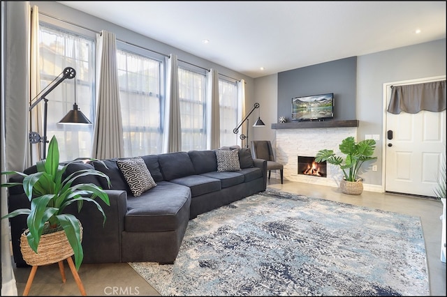 living room featuring a stone fireplace