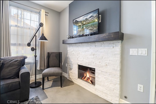 living area featuring a stone fireplace