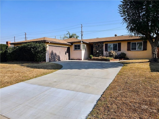 single story home featuring a front yard and a garage