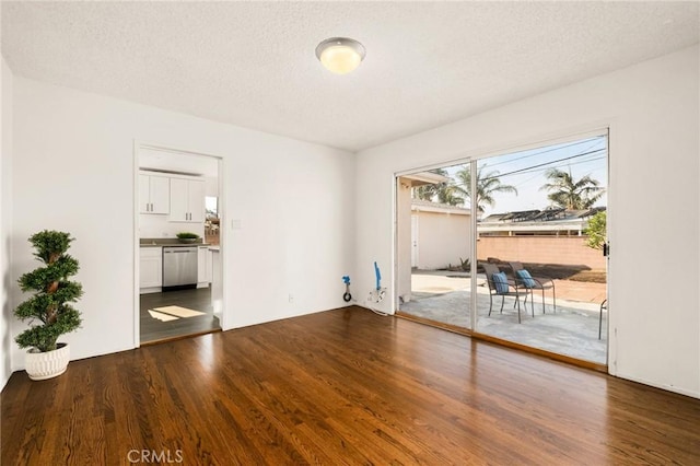 empty room featuring a textured ceiling and hardwood / wood-style flooring