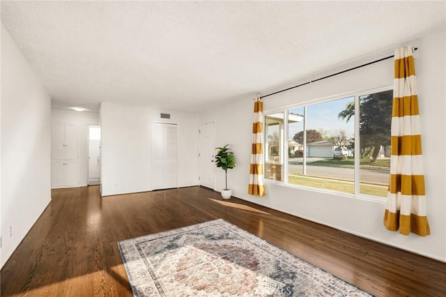 unfurnished room featuring dark hardwood / wood-style floors