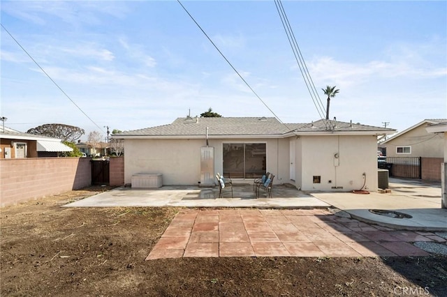 back of house with central air condition unit and a patio area