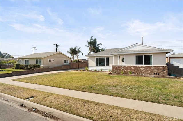 ranch-style house featuring a front yard