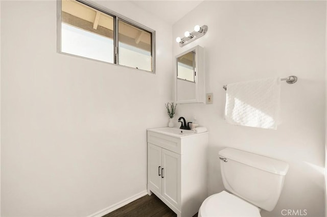 bathroom featuring vanity, toilet, and wood-type flooring