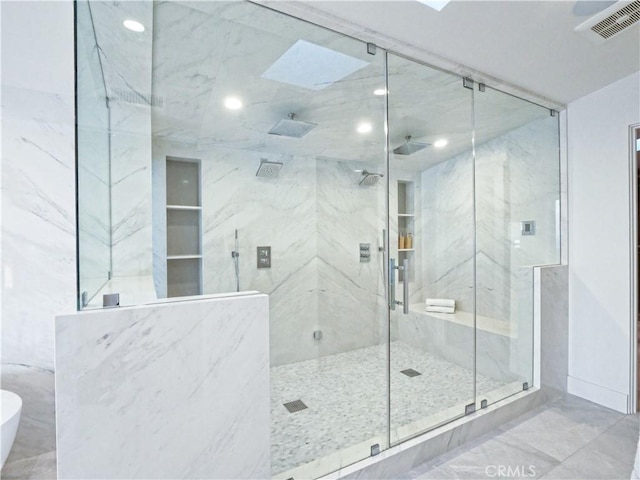 bathroom with ceiling fan and walk in shower