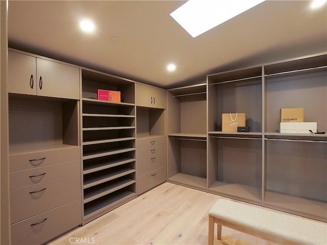 walk in closet with light hardwood / wood-style floors