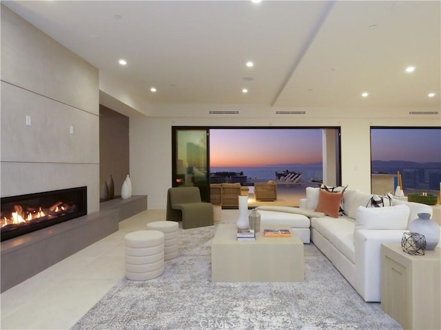 living room with a tile fireplace