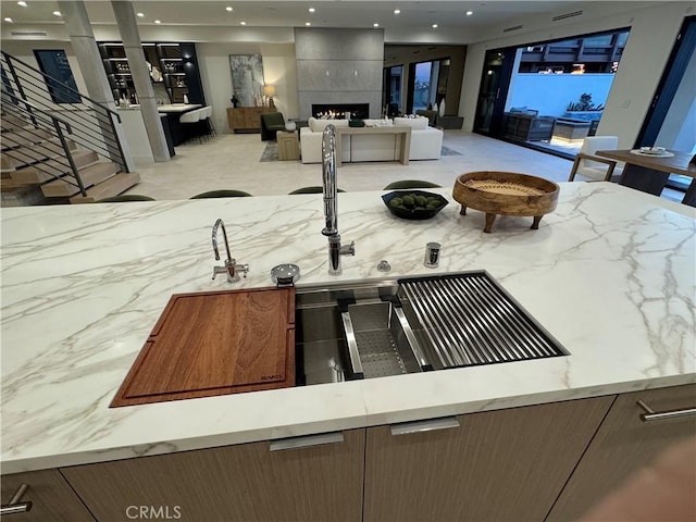 interior space featuring light stone counters and a fireplace