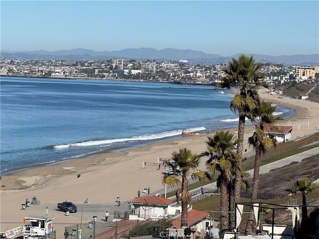 property view of water featuring a mountain view and a beach view