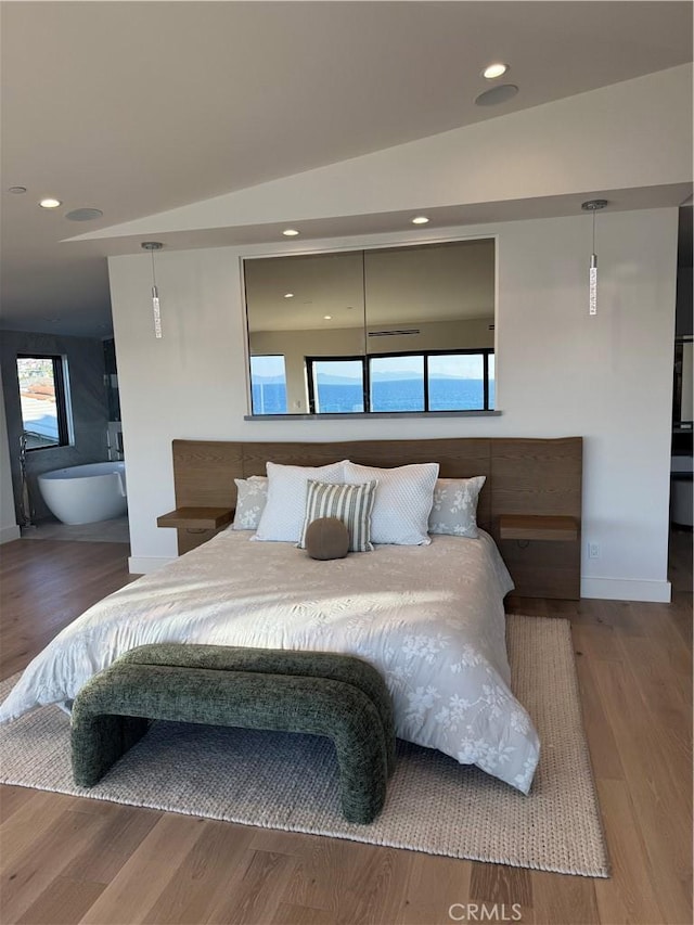 bedroom with hardwood / wood-style flooring and vaulted ceiling