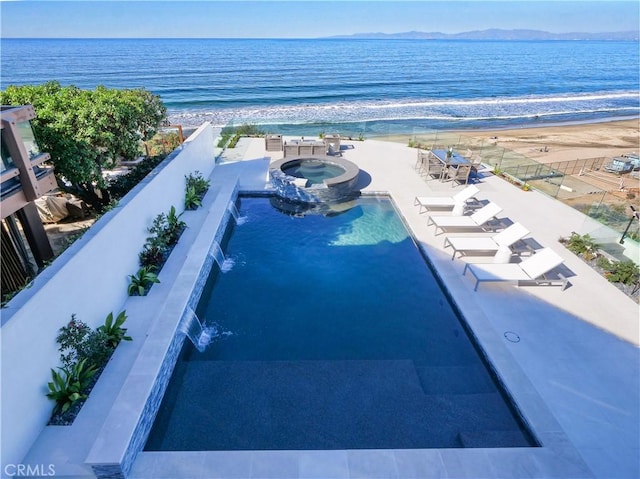 exterior space featuring a water view and a view of the beach