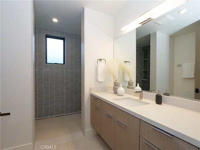 bathroom featuring vanity and a tile shower