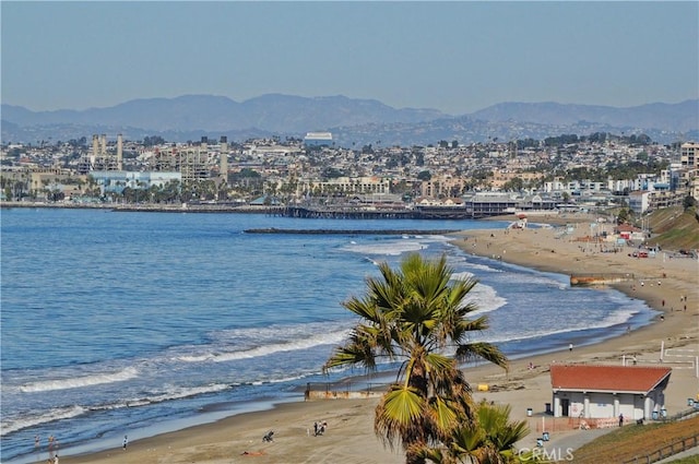 view of water feature with a mountain view and a view of the beach