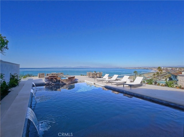 view of pool featuring pool water feature and a water view