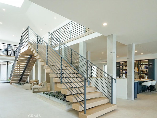 staircase with a towering ceiling