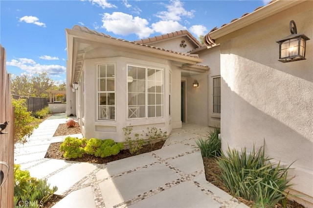 view of exterior entry with a patio