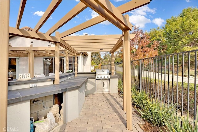 view of patio with a pergola, area for grilling, and exterior kitchen